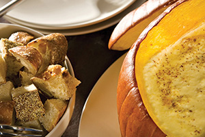 Artichoke and fall fruit fondue in a pumpkin