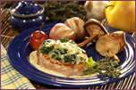 Pork Tenderloin Stuffed with Brie, Spinach, Cranberries, and White Wine Sauce