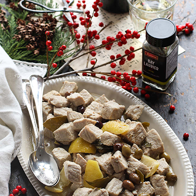 Pork stew with lemon, olives, and bay leaves