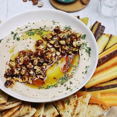 White bean and roasted garlic dip, topped with crunchy bumble bloom garnish